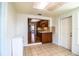 Dining area with tile floors open to a kitchen with wooden cabinetry and bar seating at 2710 Fairmount Ave, Lakeland, FL 33803