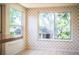 Dining room with floral wallpaper and large windows overlooking the yard at 2710 Fairmount Ave, Lakeland, FL 33803