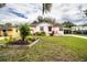 A charming home with a well-kept lawn and landscaping and a front porch with chairs at 2710 Fairmount Ave, Lakeland, FL 33803
