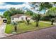Traditional single story home features a front porch, carport, and a well landscaped front yard at 2710 Fairmount Ave, Lakeland, FL 33803