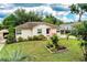 A quaint single-story home featuring a front porch and carport, set in a landscaped front yard at 2710 Fairmount Ave, Lakeland, FL 33803