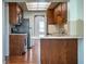 Galley kitchen with stainless appliances and wood cabinets opening to separate dining space at 2710 Fairmount Ave, Lakeland, FL 33803