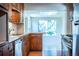 Well-lit kitchen featuring wood cabinets, stainless appliances and views to a bright breakfast nook at 2710 Fairmount Ave, Lakeland, FL 33803