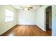 Spacious living room showcasing laminate flooring, a ceiling fan, and abundant natural light at 2710 Fairmount Ave, Lakeland, FL 33803