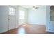 Well-lit living room boasts wood-look floors, a ceiling fan, and a welcoming ambiance at 2710 Fairmount Ave, Lakeland, FL 33803