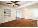 Bright living room featuring wood-look floors and a built-in shelving unit at 2710 Fairmount Ave, Lakeland, FL 33803