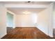 Charming living room featuring wood-look floors and an arched doorway, providing a welcoming space at 2710 Fairmount Ave, Lakeland, FL 33803