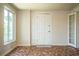 Bright living room featuring a large window, door, and unique tiled flooring at 2710 Fairmount Ave, Lakeland, FL 33803