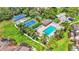 Stunning aerial view of community amenities including a pool, clubhouse, and tennis courts at 30 Aspen Dr # 30, Haines City, FL 33844