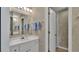 Tidy bathroom with a single sink vanity, a large mirror and a shower behind a door at 30 Aspen Dr # 30, Haines City, FL 33844