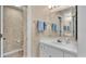 Tidy bathroom with a single sink vanity, a large mirror and a toilet behind a door at 30 Aspen Dr # 30, Haines City, FL 33844