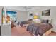 Charming bedroom featuring two twin beds, a ceiling fan, and a bright window with natural light at 30 Aspen Dr # 30, Haines City, FL 33844