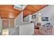 Cozy sitting area with wood plank ceilings and a view of the entryway and stairs at 30 Aspen Dr # 30, Haines City, FL 33844