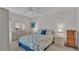 Well-lit main bedroom with floral bedspread and side tables at 30 Aspen Dr # 30, Haines City, FL 33844