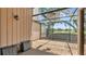 Large screened-in patio with view of manicured backyard and surrounding trees, great for entertaining at 30 Aspen Dr # 30, Haines City, FL 33844