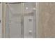 The all white shower has tiled walls, a sliding glass door and built in shelves at 30 Aspen Dr # 30, Haines City, FL 33844