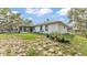 A large backyard with a covered patio offers space for outdoor living at 306 Olmo Ct, Winter Haven, FL 33880