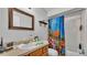 Bathroom featuring a colorful shower curtain, wooden vanity, and subway tiled shower at 306 Olmo Ct, Winter Haven, FL 33880