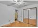 Bedroom featuring a ceiling fan, closet with mirrored doors, and doorway to a room at 306 Olmo Ct, Winter Haven, FL 33880