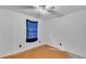 Bedroom featuring a ceiling fan, natural light, and damaged floors at 306 Olmo Ct, Winter Haven, FL 33880