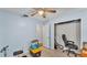 Bedroom with blue walls, featuring a ceiling fan and closet with an open door at 306 Olmo Ct, Winter Haven, FL 33880