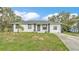 Charming single-story home with well-maintained lawn and complementary landscaping at 306 Olmo Ct, Winter Haven, FL 33880