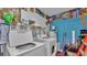 Utility Room complete with a washer, dryer, shelving and vibrant wall decor at 306 Olmo Ct, Winter Haven, FL 33880