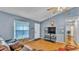 Spacious living room featuring wood-look flooring, ceiling fan, and sliding glass doors at 306 Olmo Ct, Winter Haven, FL 33880