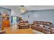 Spacious living room featuring wood-look flooring, ceiling fan, and sliding glass doors at 306 Olmo Ct, Winter Haven, FL 33880