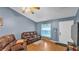 Spacious living room featuring wood-look flooring, ceiling fan, and sliding glass doors at 306 Olmo Ct, Winter Haven, FL 33880