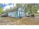 A large shed with double doors offers extra storage at 306 Olmo Ct, Winter Haven, FL 33880