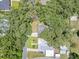Aerial view showcases the home's roof and proximity to mature tree coverage at 312 Palencia Pl, Lakeland, FL 33803