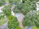 Bird's eye view of the home highlighting the roof and surrounding lush trees at 312 Palencia Pl, Lakeland, FL 33803
