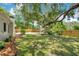 Fenced backyard with mature trees and lush lawn at 312 Palencia Pl, Lakeland, FL 33803