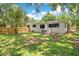 Expansive backyard featuring lush green grass and a charming wooden fence offering privacy at 312 Palencia Pl, Lakeland, FL 33803