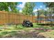 Fenced yard with trampoline and toy car offers a great play area at 312 Palencia Pl, Lakeland, FL 33803