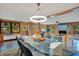 Dining room with a glass table, wood paneling, and modern light fixture at 312 Palencia Pl, Lakeland, FL 33803