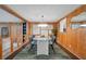 Elegant dining area features wood paneling, a stylish light fixture, and a glass-top table for modern dining experiences at 312 Palencia Pl, Lakeland, FL 33803