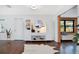 Sun-filled entryway with hardwood floors, white walls, and curated modern decor at 312 Palencia Pl, Lakeland, FL 33803