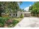 Home exterior showing covered parking, chimney, and manicured landscaping at 312 Palencia Pl, Lakeland, FL 33803