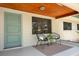 Cozy front porch features chairs, a welcome mat, and a painted front door at 312 Palencia Pl, Lakeland, FL 33803