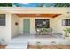 Charming front porch with seating area and attractive, newly painted entry door at 312 Palencia Pl, Lakeland, FL 33803