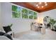 Bright home office with view of lush landscaping through large window at 312 Palencia Pl, Lakeland, FL 33803