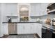 Modern kitchen with white cabinetry, stainless steel appliances, and stylish tile backsplash at 312 Palencia Pl, Lakeland, FL 33803