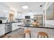 Modern kitchen with white cabinets, subway tile backsplash, and stainless steel appliances at 312 Palencia Pl, Lakeland, FL 33803