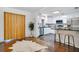 View of kitchen with white cabinets, island seating and wooden sliding door at 312 Palencia Pl, Lakeland, FL 33803