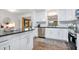 Bright kitchen with white cabinets, granite countertops, and stainless steel appliances at 312 Palencia Pl, Lakeland, FL 33803