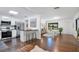 Bright kitchen with stainless steel appliances, breakfast bar, and hardwood floors at 312 Palencia Pl, Lakeland, FL 33803