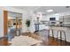 Open-concept kitchen with white cabinets, stainless steel appliances, and breakfast bar at 312 Palencia Pl, Lakeland, FL 33803