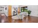 Bright, sunlit living area with hardwood floors, stylish decor, and comfortable seating, perfect for relaxation at 312 Palencia Pl, Lakeland, FL 33803